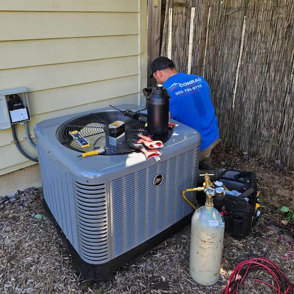 Conrad HVAC tech installing condensor