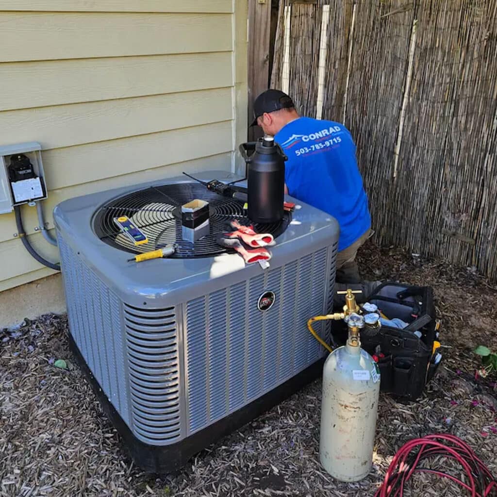 Conrad HVAC tech repairing condensor