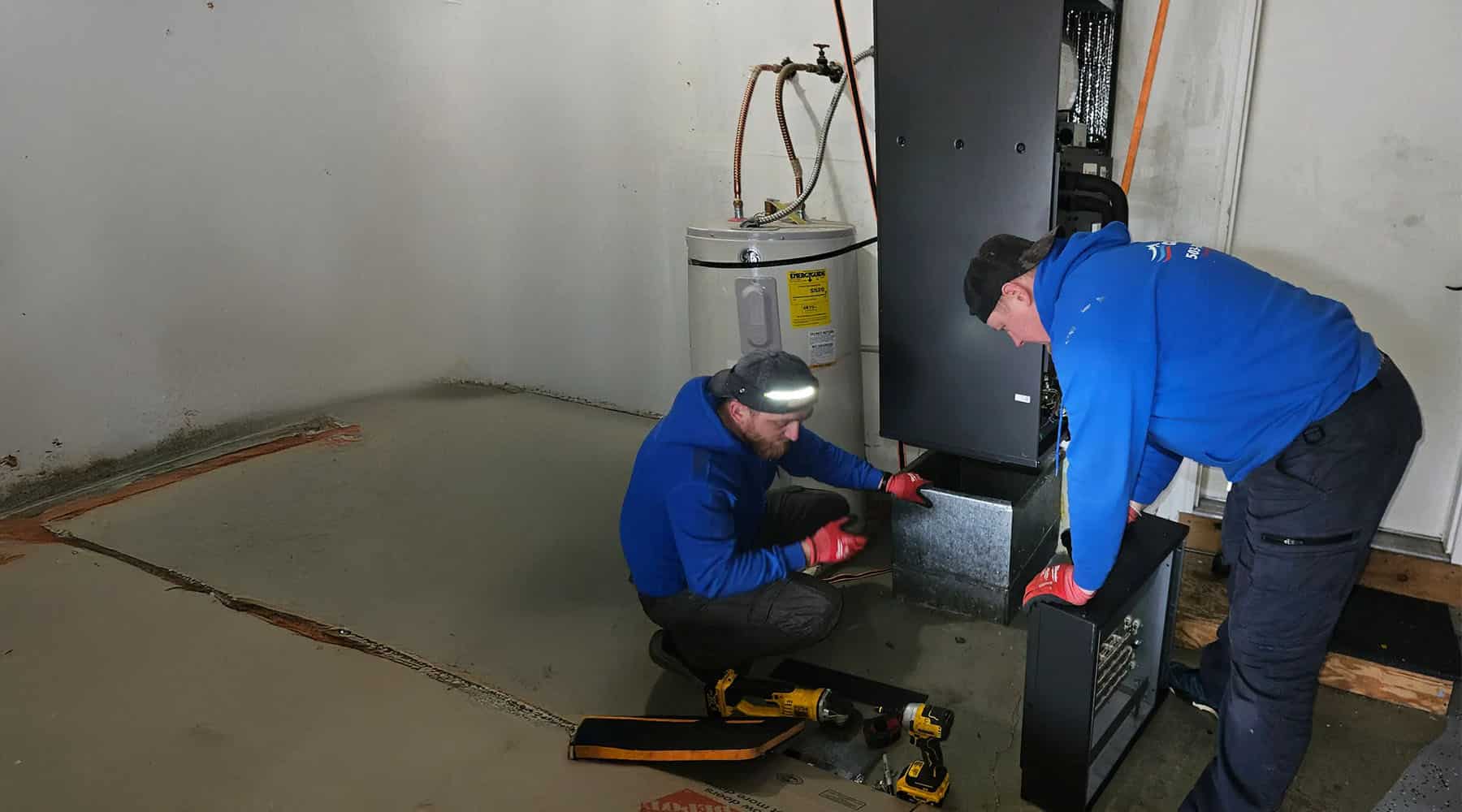Two Conrad HVAC tech working on furnace