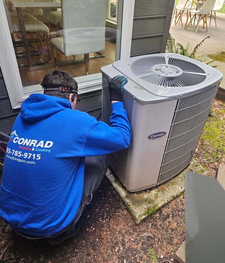 Conrad's technician repairs an air conditioner