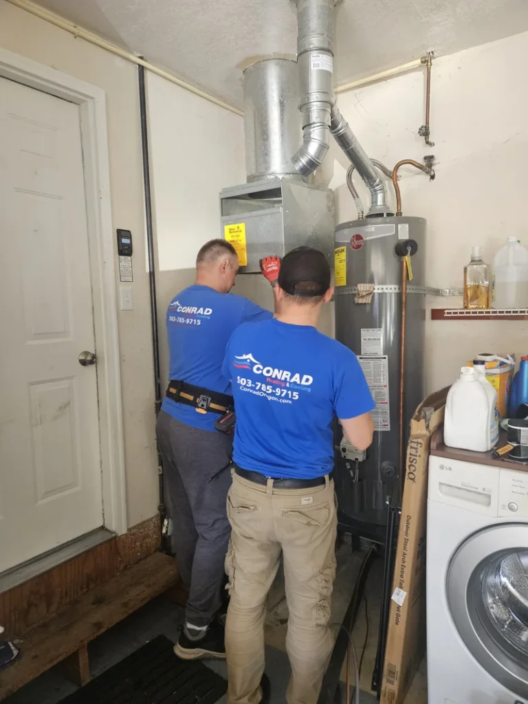 Conrad HVAC technicians installing a furnace in a Portland metro home